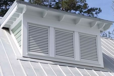 Close-up view of a custom gable vent being installed on a roof gable