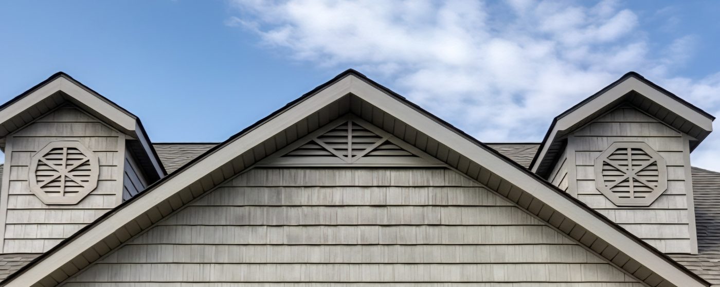Wide angle view of a house exterior featuring multiple custom metal gable vents