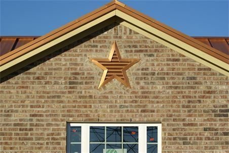 Close-up view of a stylish gable vent being installed on a house
