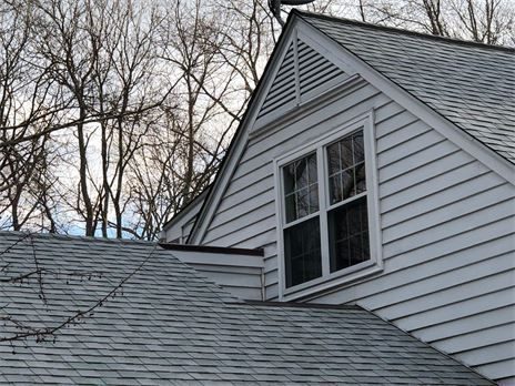 Close-up view of a wooden gable vent installed on a house exterior