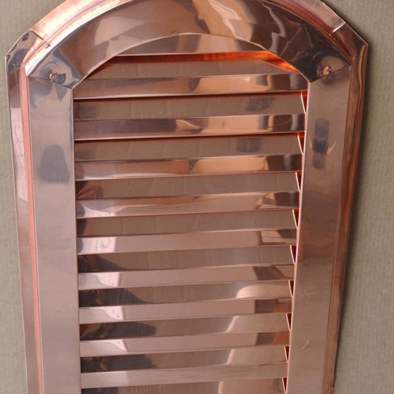 Copper arch top gable vent with bright copper louvers