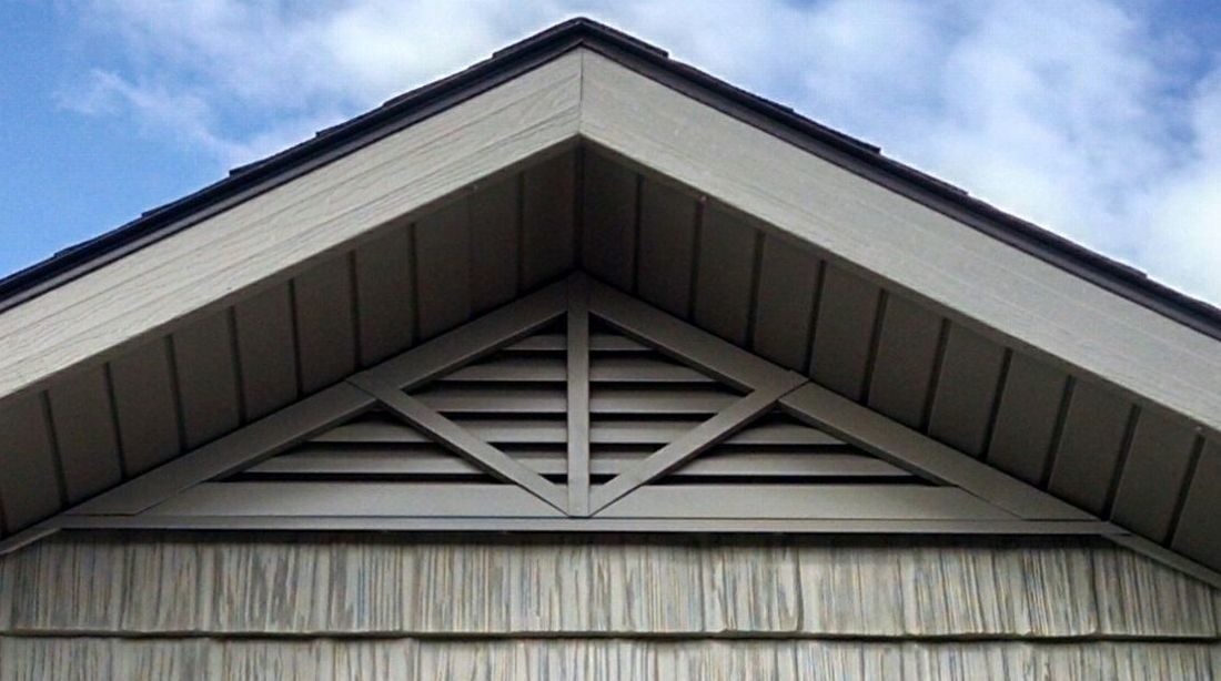 Aluminum triangle gable vent with three decorative spokes, installed under the roof peak