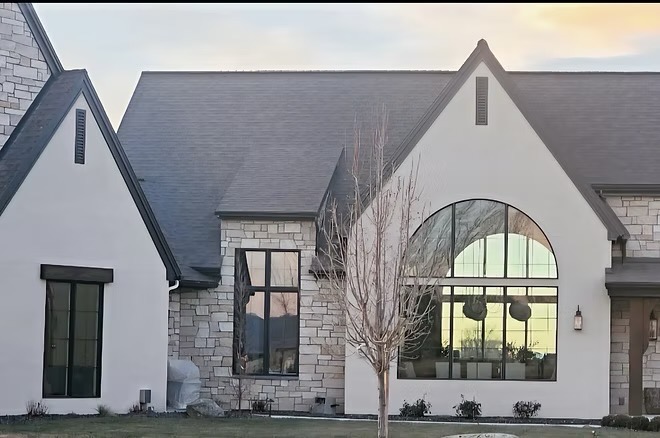 White stucco home with two slim, tall gable vents in the peaks