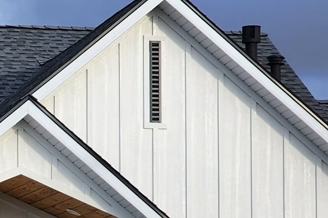 Slim black vent in a white board-and-batten gable